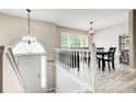 Bright dining area with stylish light fixtures, views to the main entrance and hardwood flooring at 407 Yellowstone Dr, Powder Springs, GA 30127