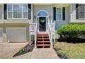 Inviting front entrance showcasing a well-maintained walkway and a charming front door at 407 Yellowstone Dr, Powder Springs, GA 30127
