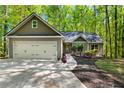 Inviting home exterior with a well-manicured yard and a two-car attached garage at 191 Orchard Dr, Canton, GA 30115