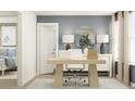 Bright home office with modern desk, stylish decor, and ample natural light through two windows at 2470 Cotton Ln, Douglasville, GA 30135