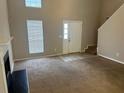 Bright living room with a fireplace, staircase, neutral walls, and lots of natural light at 4963 Windsor Downs Ln, Decatur, GA 30035