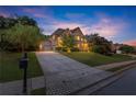 Inviting brick home with a well-manicured lawn, long driveway, and mature trees at 979 Pathview Ct, Dacula, GA 30019