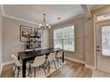 Charming dining room featuring a black table, elegant chandelier, and shelf decor at 1203 Penhurst Way, Lawrenceville, GA 30043
