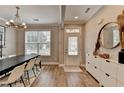 Charming dining room featuring hard wood floors, an elegant chandelier, and a large window at 1203 Penhurst Way, Lawrenceville, GA 30043