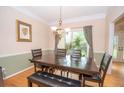 Cozy dining area with a dark wood table and ample natural light creating a warm atmosphere at 155 Redspire Ln, Fayetteville, GA 30215