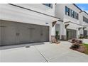 Townhome exterior featuring a driveway, two-car garage and manicured landscaping at 709 Dodd Ln # 165, Buford, GA 30518