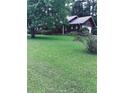 Traditional home on a spacious lot with lush green grass and mature trees at 5475 Morning Creek Cir, Atlanta, GA 30349