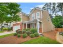 Charming two-story home featuring a manicured lawn, brick accents, and a welcoming front porch at 728 Lorimore Pass, Canton, GA 30115