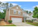 Charming two-story home with a well-manicured lawn, a two-car garage, and a welcoming front entrance at 728 Lorimore Pass, Canton, GA 30115