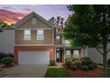 Charming two-story home with a well-manicured lawn, a two-car garage, and a welcoming front entrance at 728 Lorimore Pass, Canton, GA 30115