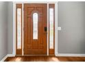 Elegant wooden front door featuring decorative glass sidelights and panels at 1440 Boundary Blvd, Suwanee, GA 30024