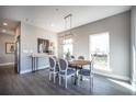 Dining area with an oval table, comfortable seating, stylish light fixture, and natural light at 1741 Prospect Way, Conyers, GA 30094
