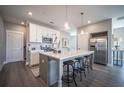 Bright kitchen with white cabinets, stainless steel appliances, and a large island with seating at 1741 Prospect Way, Conyers, GA 30094