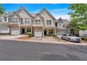 View of the townhouse with stone accents, garage, and manicured landscaping in a well-kept neighborhood at 2205 Hoskin Nw Ct # 9, Kennesaw, GA 30144