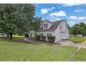 Beautiful house with a well maintained lawn, beautiful tree, and white siding at 3885 Riverview Chase Blf, Ellenwood, GA 30294