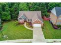 Expansive aerial view showcasing the lush lawn and meticulously landscaped garden at 4235 Crestwood Bend Cir, Buford, GA 30518