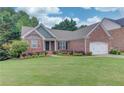 Well-maintained front yard with vibrant flowerbeds that accents the home's facade at 4235 Crestwood Bend Cir, Buford, GA 30518
