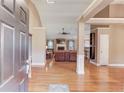 Open floor plan with hardwood floors and a cozy living room featuring a fireplace at 4235 Crestwood Bend Cir, Buford, GA 30518