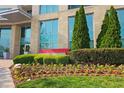 Well-maintained landscaping around the entrance of The Manhattan building provides lush curb appeal at 4561 Olde Perimeter Way # 608, Dunwoody, GA 30346