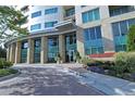 Beautifully landscaped entrance with stone columns, modern architecture, and lush greenery at 4561 Olde Perimeter Way # 608, Dunwoody, GA 30346
