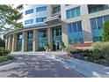 Beautiful building entrance with brick pavers, manicured landscaping and glass-walled lobby at 4561 Olde Perimeter Way # 608, Dunwoody, GA 30346