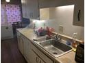 Kitchen sink with adjacent counter space and white cabinets, and an adjacent dining area at 6354 Shannon Pkwy # 26C, Union City, GA 30291