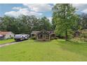 Quaint home with a welcoming front porch, situated on a spacious lot with mature trees and a green lawn at 160 Northside Ave, Dallas, GA 30157