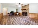 Inviting living room featuring wood-look floors, brick fireplace, and ample space for relaxing and entertaining at 160 Northside Ave, Dallas, GA 30157
