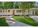Well manicured one story home with white painted brick and a single car carport at 2595 Elkhorn Dr, Decatur, GA 30034
