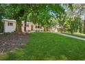 Well manicured one story home with white painted brick and a single car carport at 2595 Elkhorn Dr, Decatur, GA 30034