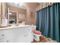 Clean bathroom featuring a white vanity, mirror, and blue shower curtain, offering a functional space at 580 River Valley Dr, Dacula, GA 30019