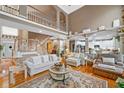 Spacious living room with hardwood floors, comfortable seating, and natural light at 580 River Valley Dr, Dacula, GA 30019