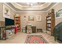 Cozy home office with custom ceiling, bookshelves, a comfortable desk, and carpet, perfect for productivity at 580 River Valley Dr, Dacula, GA 30019