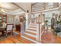 Open staircase with wooden railings and hardwood floors leading to the upper level at 580 River Valley Dr, Dacula, GA 30019