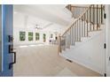 Bright, open living room with light hardwood floors, ceiling fan, and large windows for natural light at 2477 Bobbie Dr, Marietta, GA 30066
