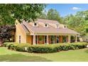 Inviting home exterior featuring dormer windows, manicured hedges, and a welcoming front porch at 221 Creekside Pass Pass, Canton, GA 30114