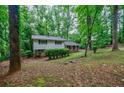 Two-story home surrounded by mature trees, offering a private and serene setting at 3294 Francine Dr, Decatur, GA 30033