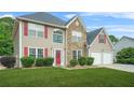 Charming two-story home featuring a well-manicured lawn and a welcoming red front door at 60 Heaton Dr, Covington, GA 30016