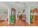 Inviting hallway featuring hardwood floors, decorative plants, and a view into the adjacent living spaces at 60 Heaton Dr, Covington, GA 30016
