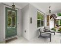 Inviting front porch showcasing painted brick, seating, and a charming green front door at 124 Calder Dr, Alpharetta, GA 30009