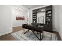 Stylish home office featuring dark built-in cabinets, hardwood floors, and a modern desk at 124 Calder Dr, Alpharetta, GA 30009