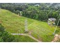 Aerial view of a lush property with electric lines and mature trees surrounding the home at 1368 Tommy Lee Cook Rd, Palmetto, GA 30268