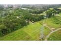 Aerial view of lush greenery and an expansive lot; electric lines are present on the property at 1368 Tommy Lee Cook Rd, Palmetto, GA 30268