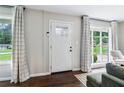 Bright living room with large windows and hardwood floors has a cozy, inviting atmosphere at 3036 Horse Shoe Se Dr, Atlanta, GA 30316