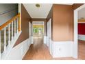 Foyer with neutral color palette, hard surface floors, and staircase to the upper level at 10795 Glenbarr Dr, Johns Creek, GA 30097