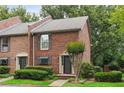 Classic brick townhome with lush green landscaping and a welcoming entrance at 1245 S Ponce De Leon Ne Ave # 13, Atlanta, GA 30306