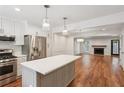 Bright, open kitchen with stainless steel appliances, white cabinets, and a center island with wood floors at 1245 S Ponce De Leon Ne Ave # 13, Atlanta, GA 30306