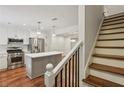 Modern kitchen features stainless appliances, a center island, and hardwood floors, adjacent to the staircase at 1245 S Ponce De Leon Ne Ave # 13, Atlanta, GA 30306