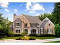 Beautiful home with stone, shingle, and brick facade, landscaped yard, and inviting front porch at 3639 Paper Mill Se Rd, Marietta, GA 30067