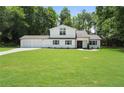 Charming two-story home features a manicured lawn, a two-car garage, and classic black shutters at 3729 Meadow Glen Cir, Ellenwood, GA 30294